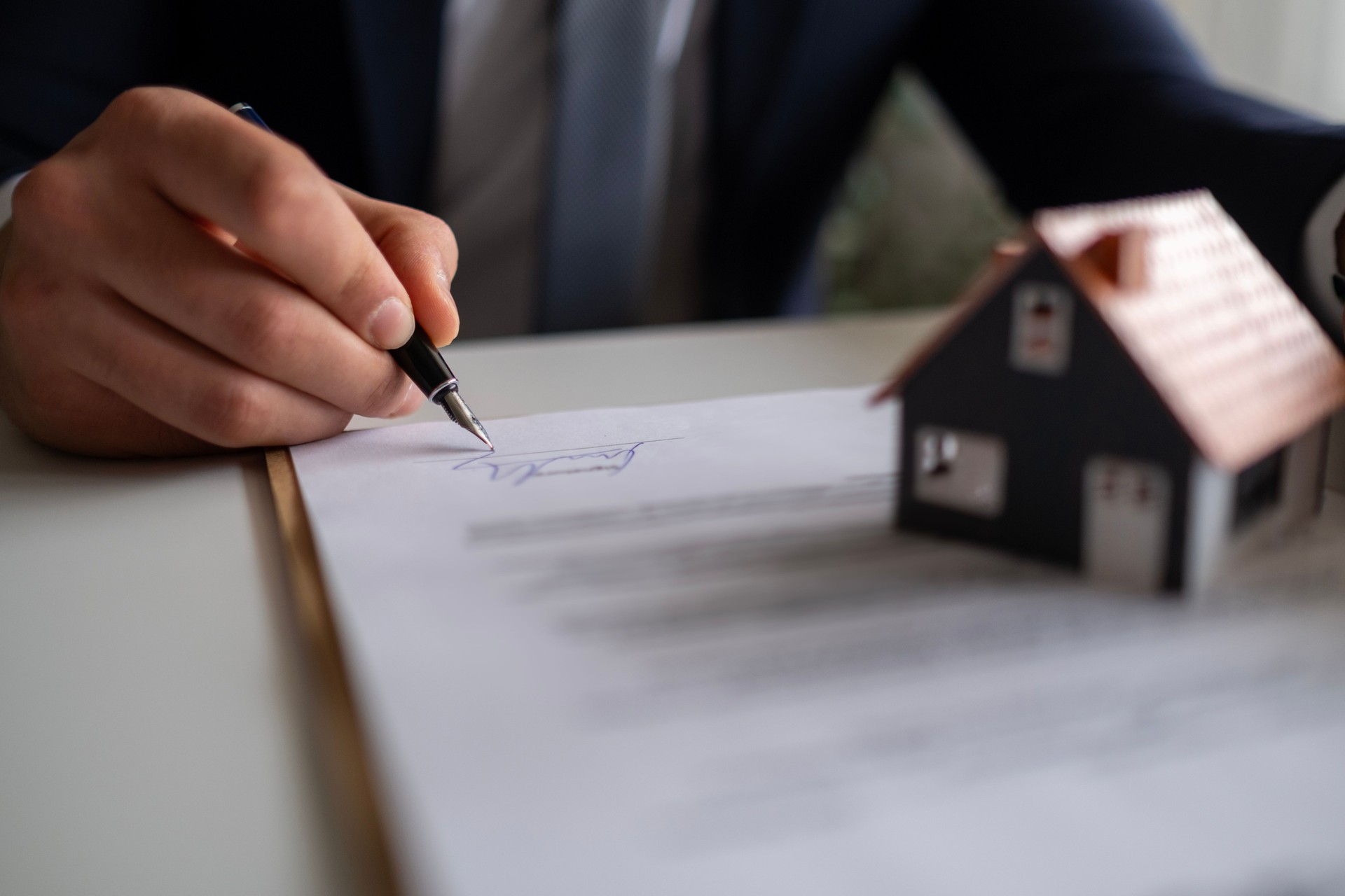 Businessman signing a legal real estate contract agreement.